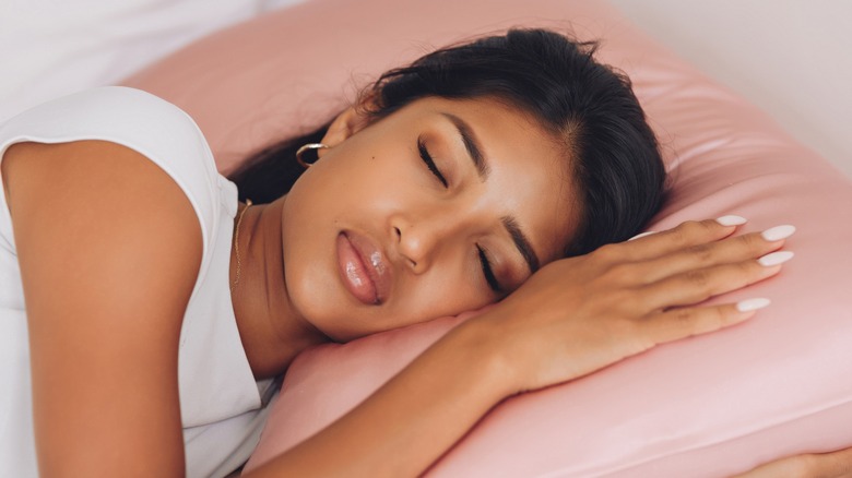 A woman sleeping on a silk pillowcase