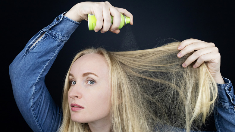 A woman using dry shampoo