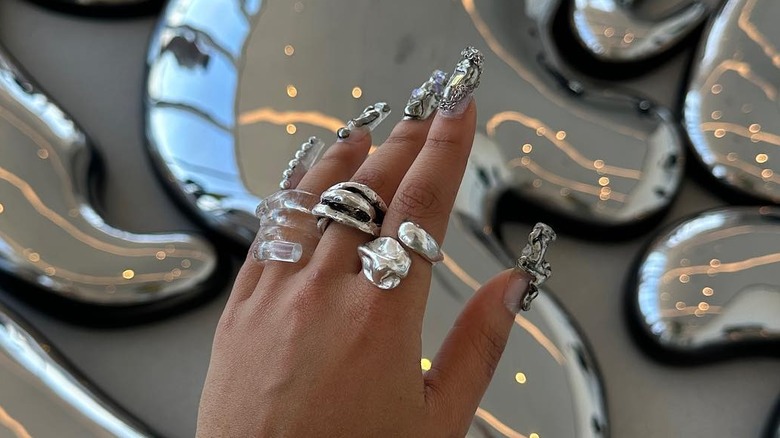silver abstract nails and bold rings