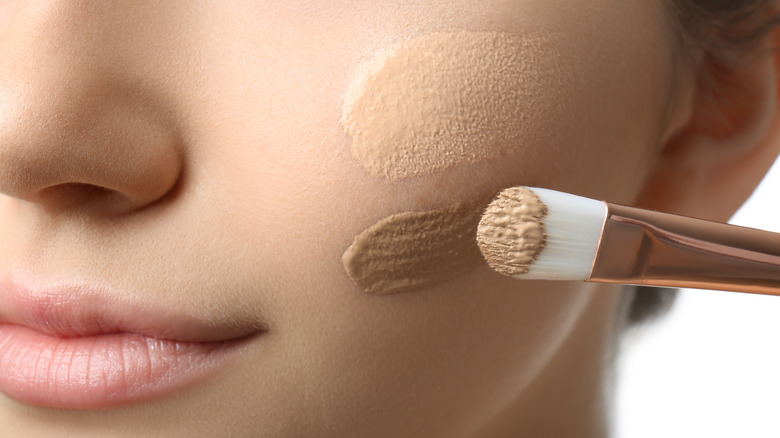 woman applying foundation