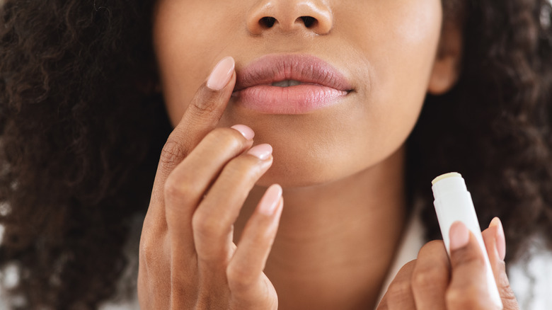 woman applying lip balm