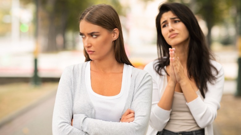 Woman begging her friend 