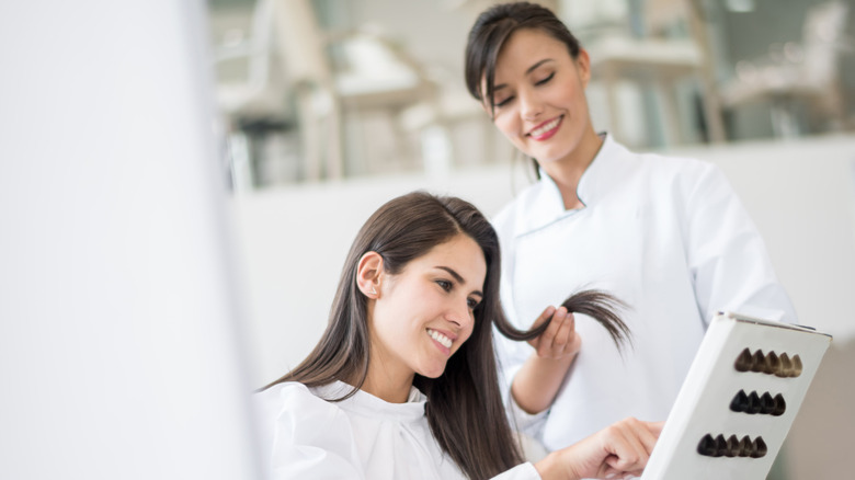 woman choosing hair color at salon