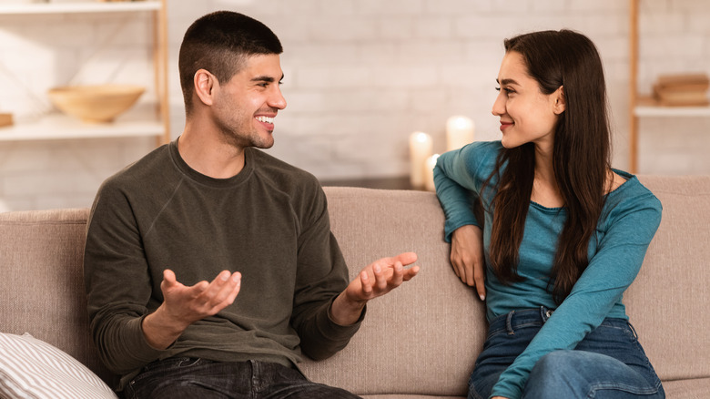 Couple having conversation on couch