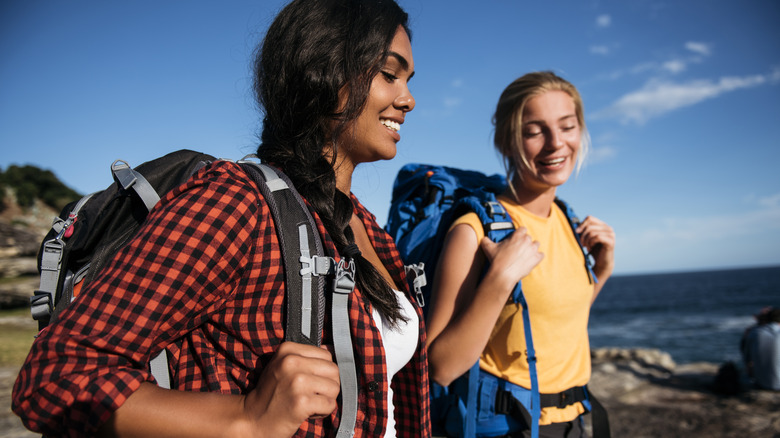 Two friends talking while hiking