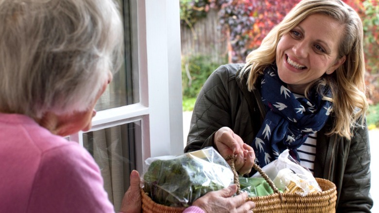 Woman helps neighbor with groceries