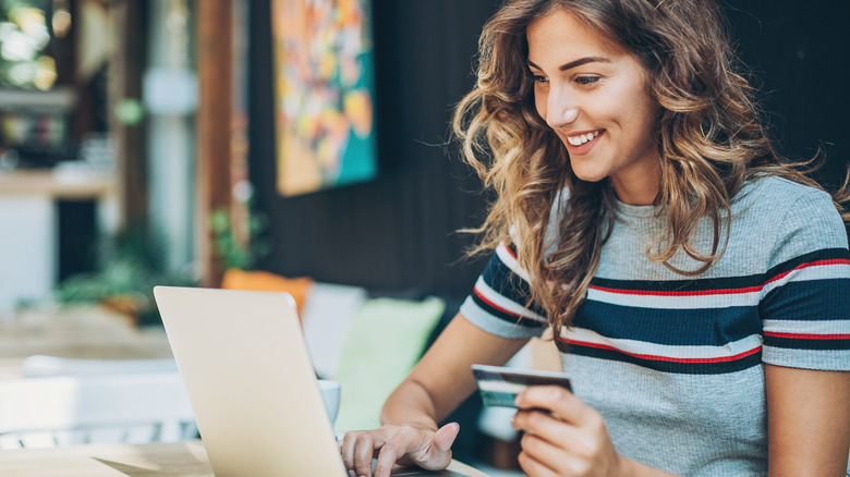 woman using credit card laptop