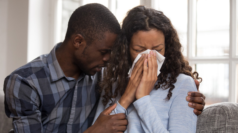 Husband holding crying wife