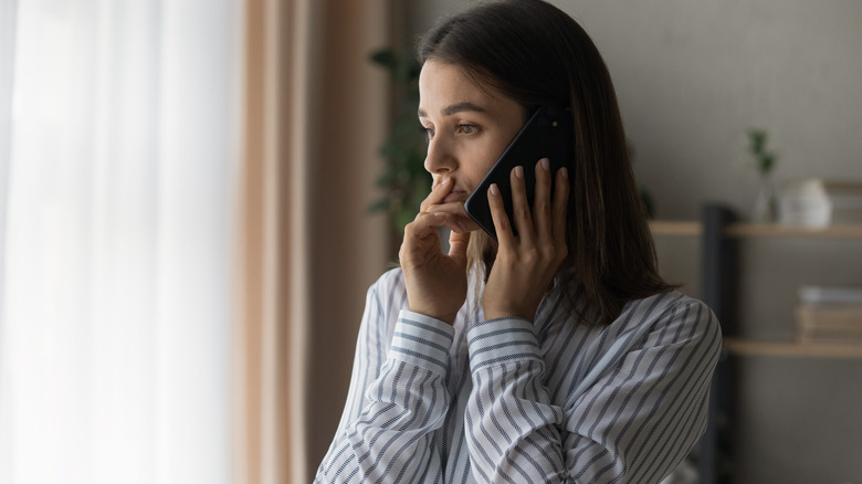 Cautious woman makes phone call