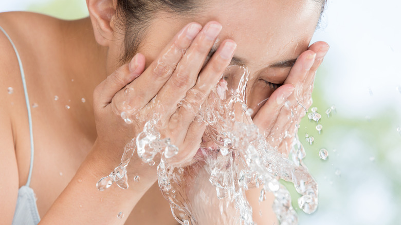 Asian woman washing her face