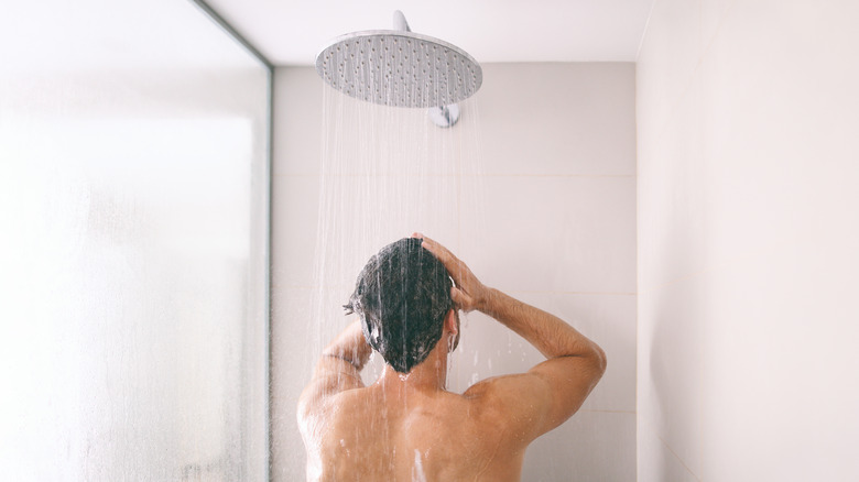 man facing away in shower