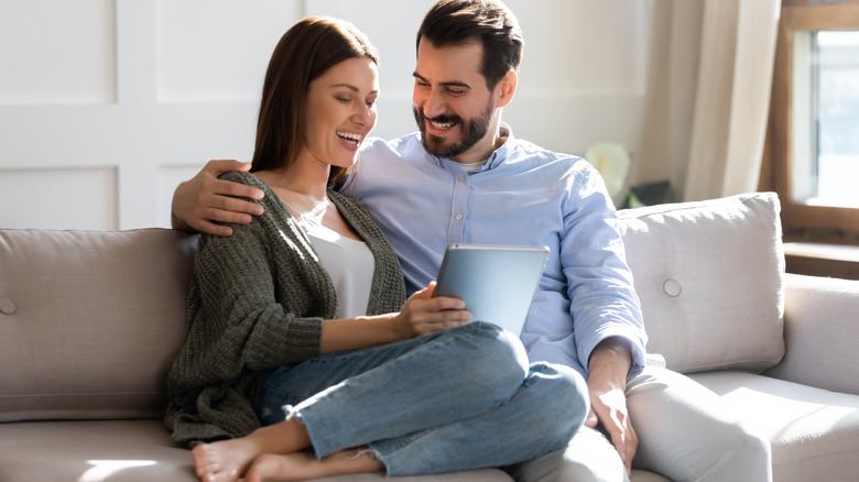 couple on sofa with tablet