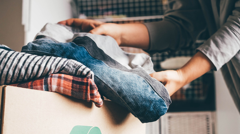 woman donating clothes from her closet