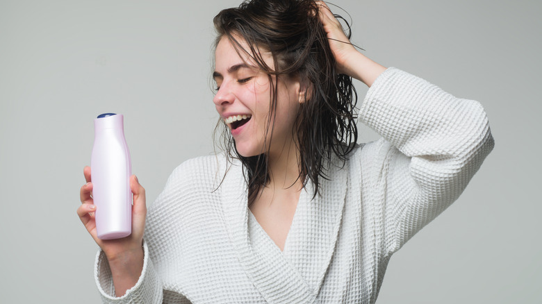 Girl with bottle of hair product 