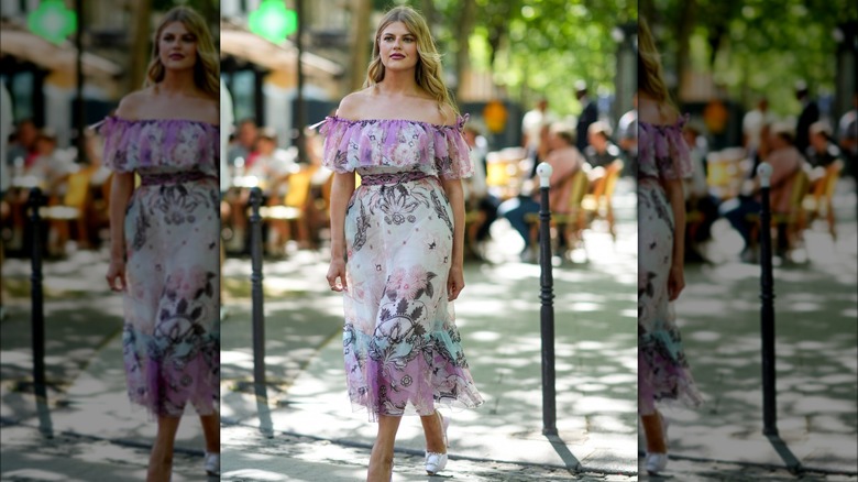 Woman in multicolored dress wearing mauve lipstick 