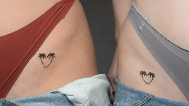 matching heart palm tree tattoos