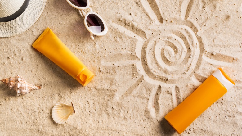 sunscreen bottles in the sand