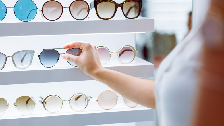 Person picking up sunglasses