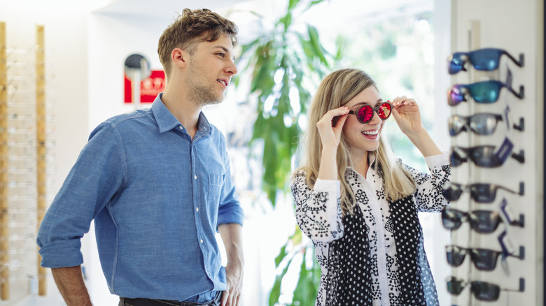 Woman shopping for sunglasses