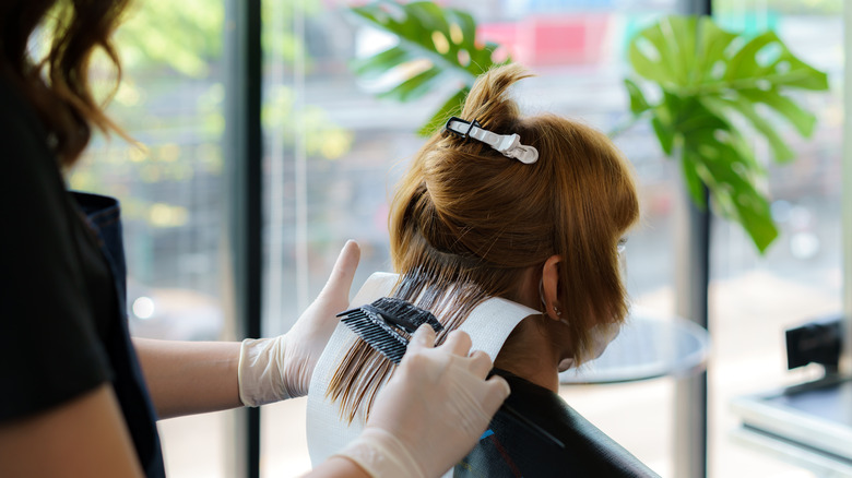 A woman getting her hair dyed