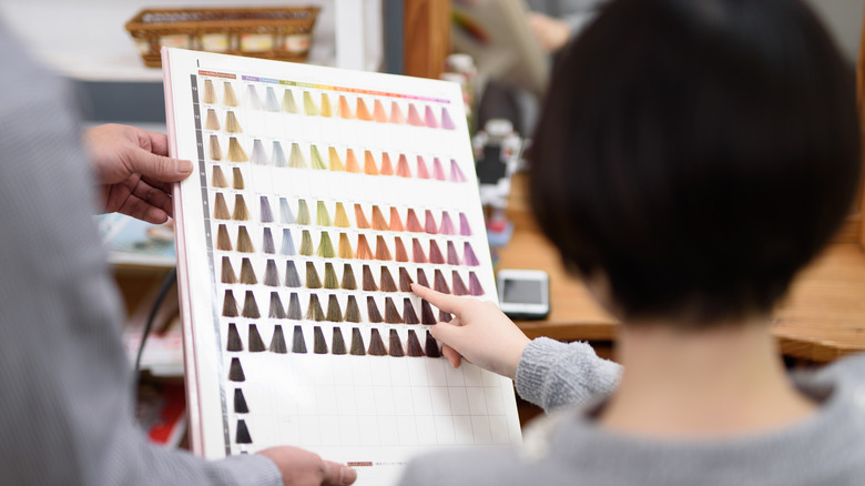 a woman picking hair colors