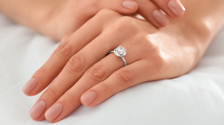 A diamond ring on a hand 