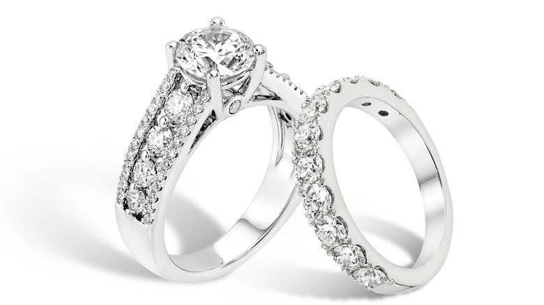 A diamond ring and wedding band on white background 