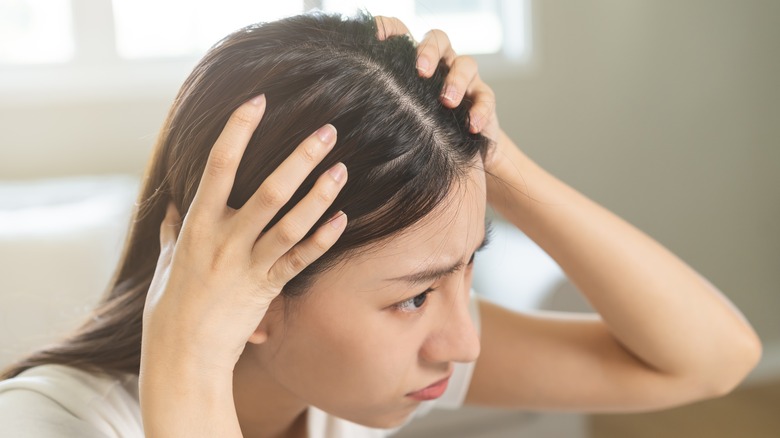 woman looking at her scalp