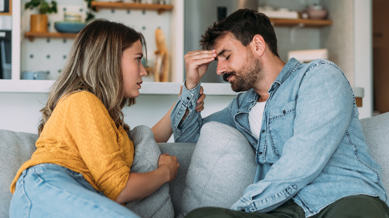 woman comforting partner at home