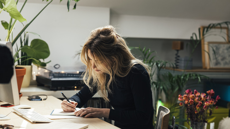 woman writing in notebook