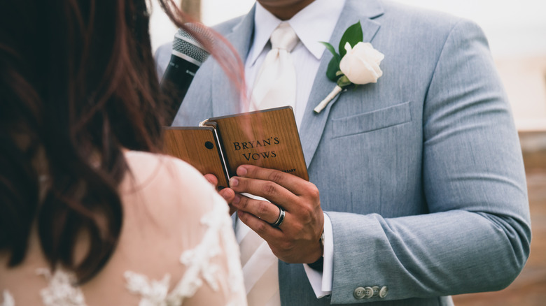 man reading vows at wedding