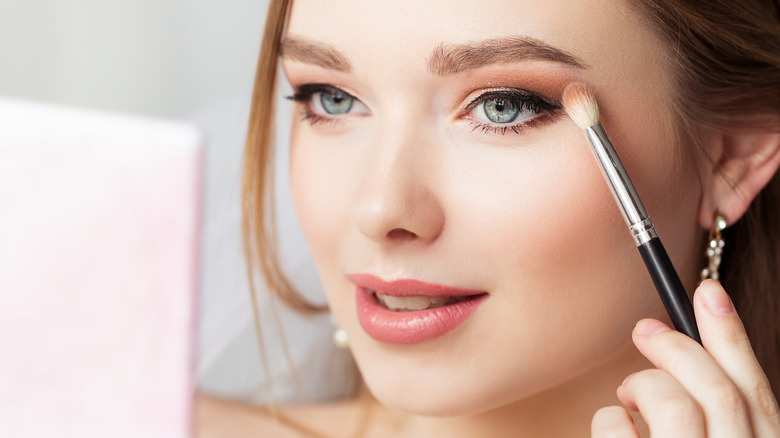 woman applying eyeshadow