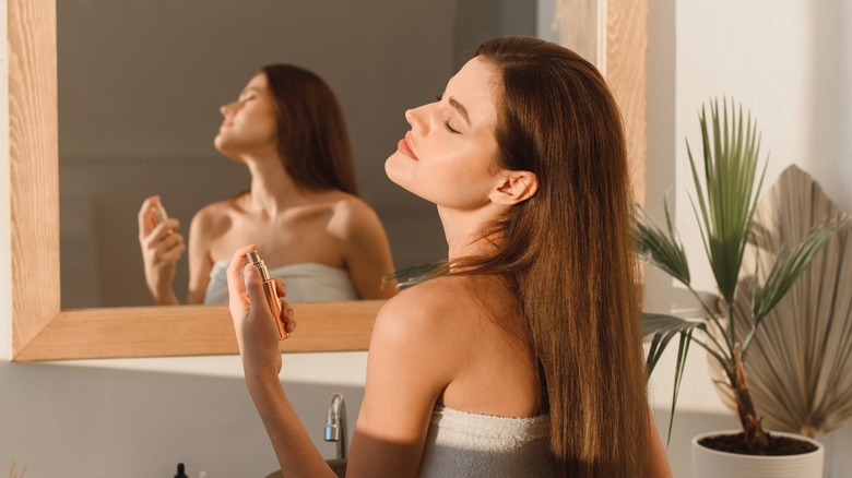 woman applying perfume