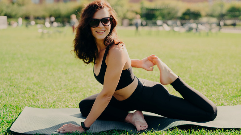 Woman wearing sunglasses while doing yoga