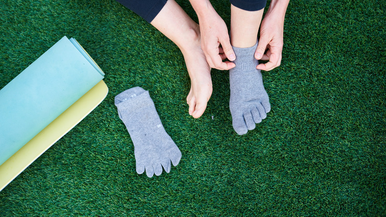 Girl putting on yoga socks