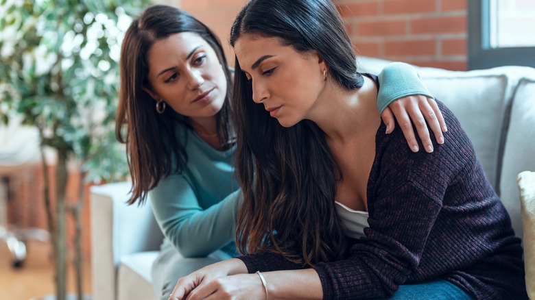 Woman comforting upset friend