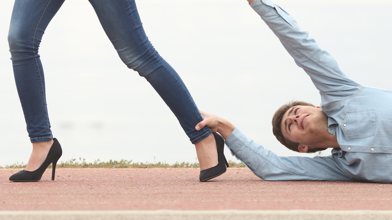 Man clinging to partner's ankle