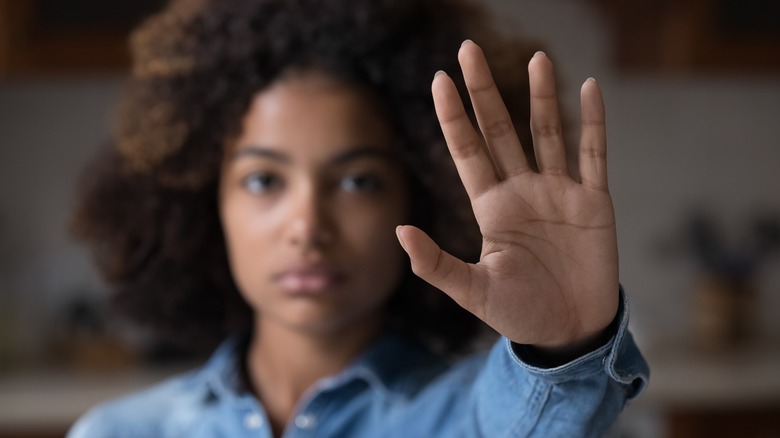 Woman holding up hand