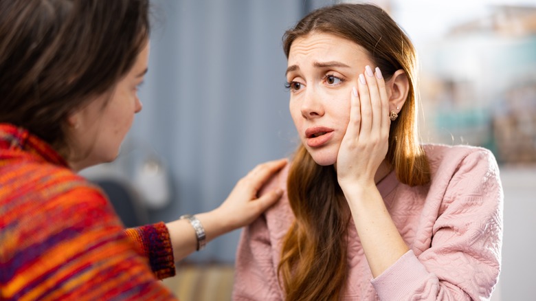 Upset woman talking to friend