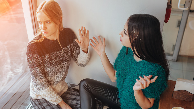 Woman ignoring negative friend