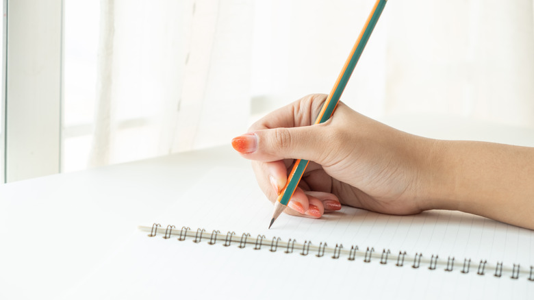 woman writing in notebook