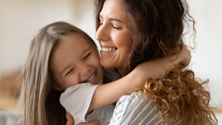 mom and daughter hugging