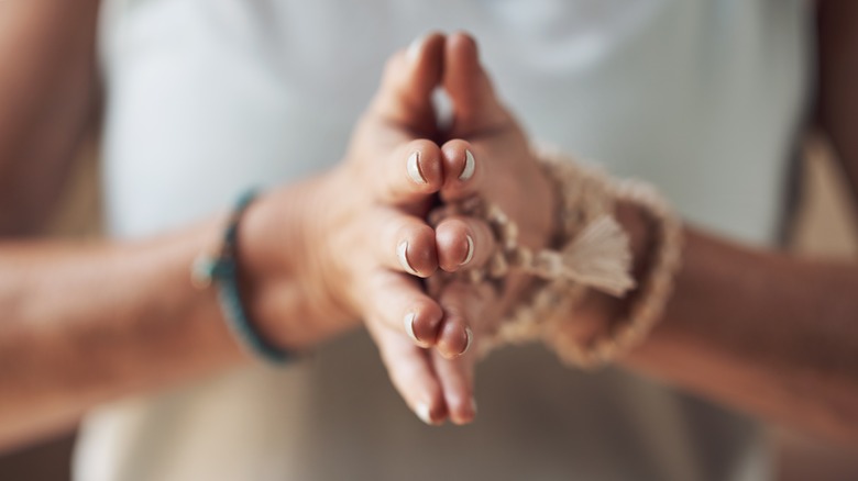 person with prayer hands