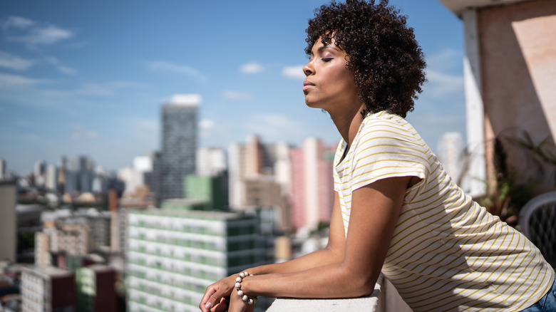 woman on patio with closed eyes