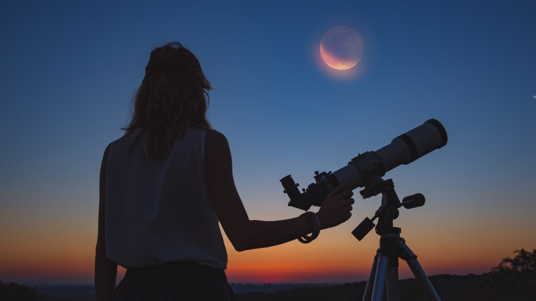 woman examining night sky