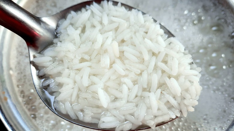spoonful of rice boiling water background