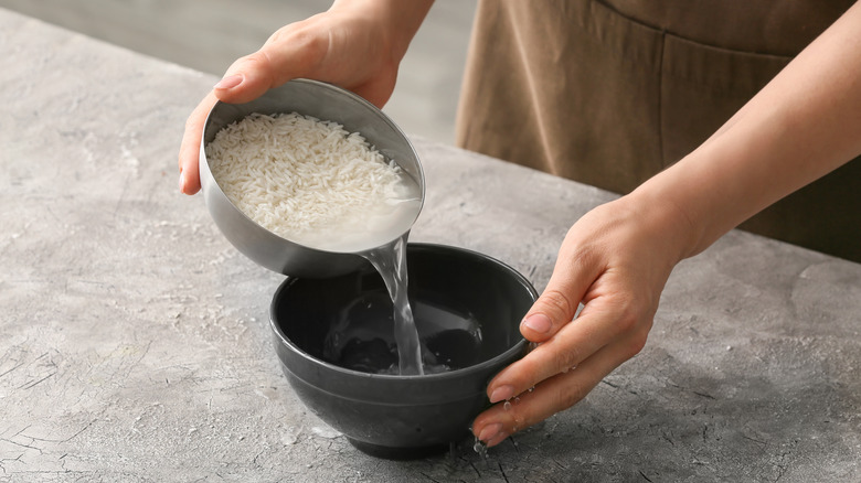 hands draining rice water