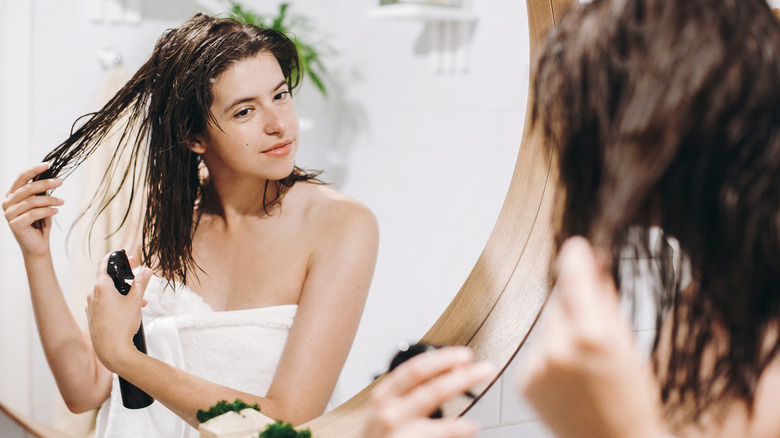 woman spraying wet hair