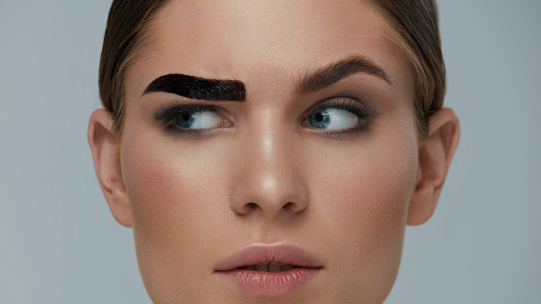 Woman with one tinted eyebrow