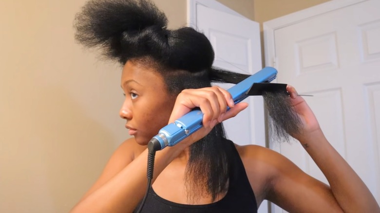 woman straightening hair with chase method